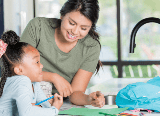 Babysitter helping child with homework