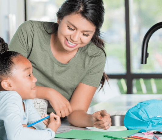 Babysitter helping child with homework