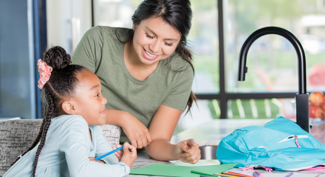 Babysitter helping child with homework
