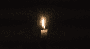 Image is of a single candle signifiying pregnancy and infant loss remembrance